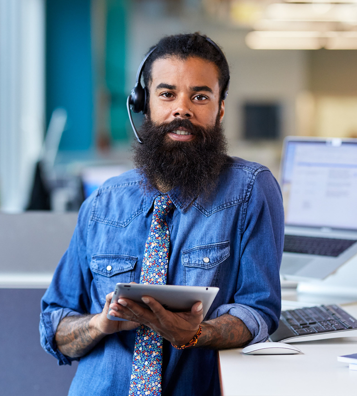 CTCT support employee with headset and tablet.