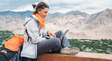 Image of woman blogging while overlooking the mountains