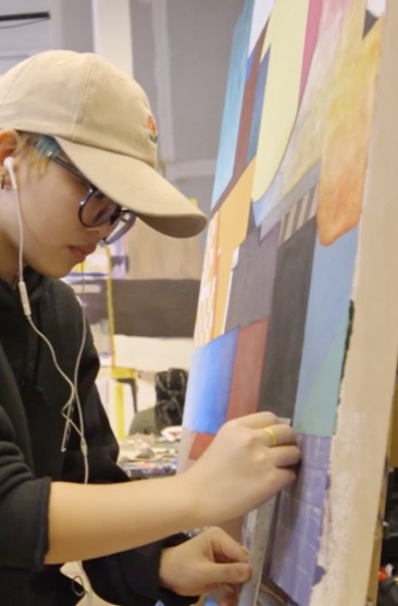 Person works on a painting at Artists for Humanity.