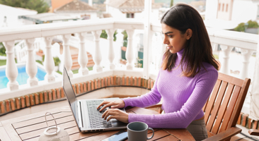 woman typing on her laptop