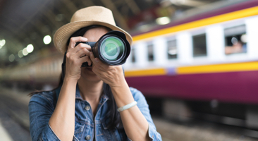 Image of photographer taking a picture at a train station