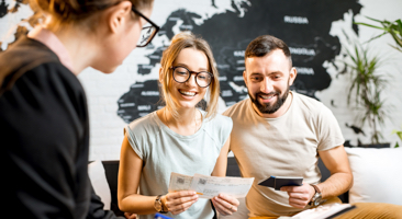 A couple meeting with a woman to have a consulation
