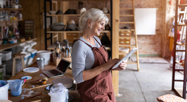 Woman in an art studio sketching on a pad
