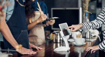 Image of a customer paying for their food at a restaurant counter