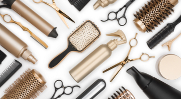 Image showing an array of hair tools including brushes, curling irons and scissors