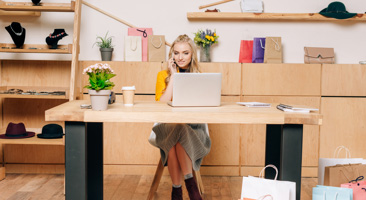 Constant Contact customer talking on the phone at their desk.