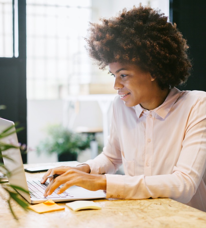 women typing on a laptop