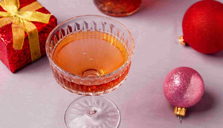 After-dinner digestif drink on a table with presents and baubles