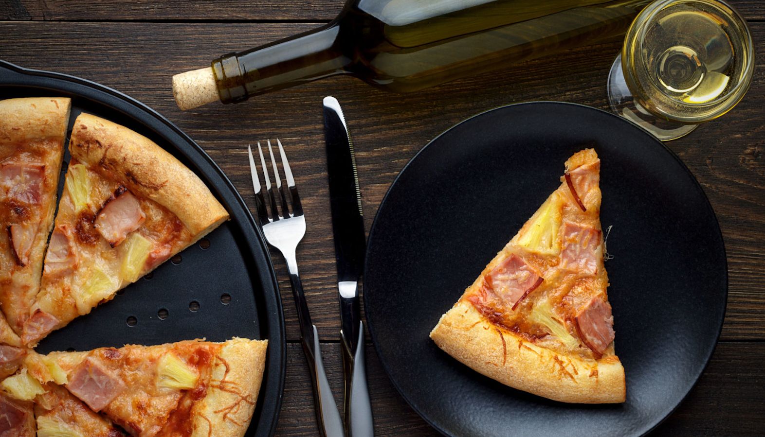 Ham and pineapple pizza with a glass of white wine - best wine with pizza