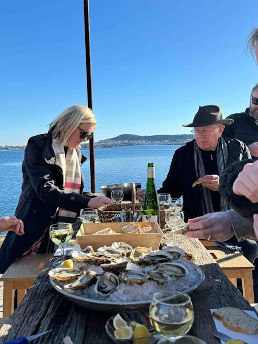 Tony and Kirsten eating oysters and drinking wine by the seafront