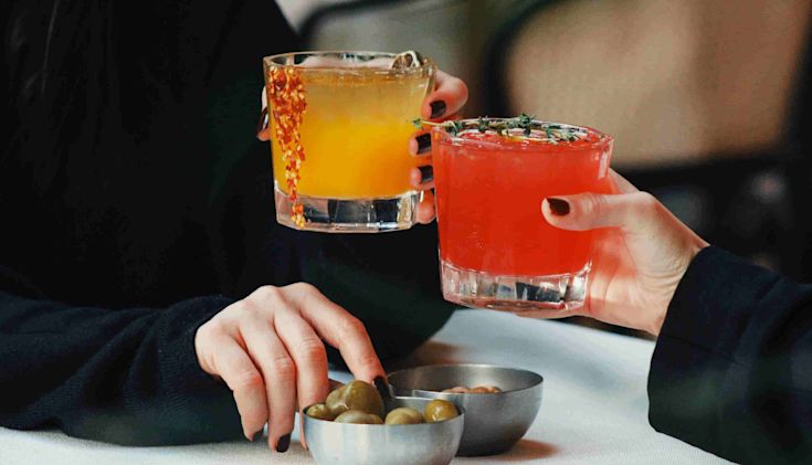 Two women enjoying cocktails together