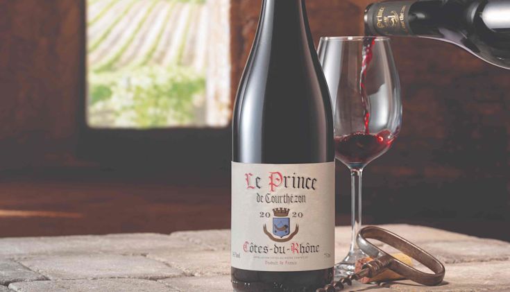 Bottle of Côtes-du-Rhône with glass and corkscrew