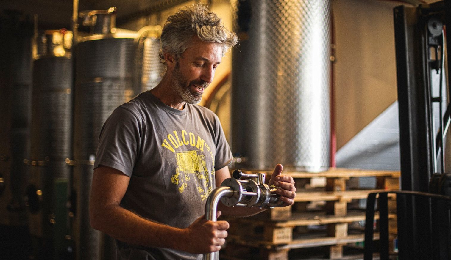 topping up a wine barrel