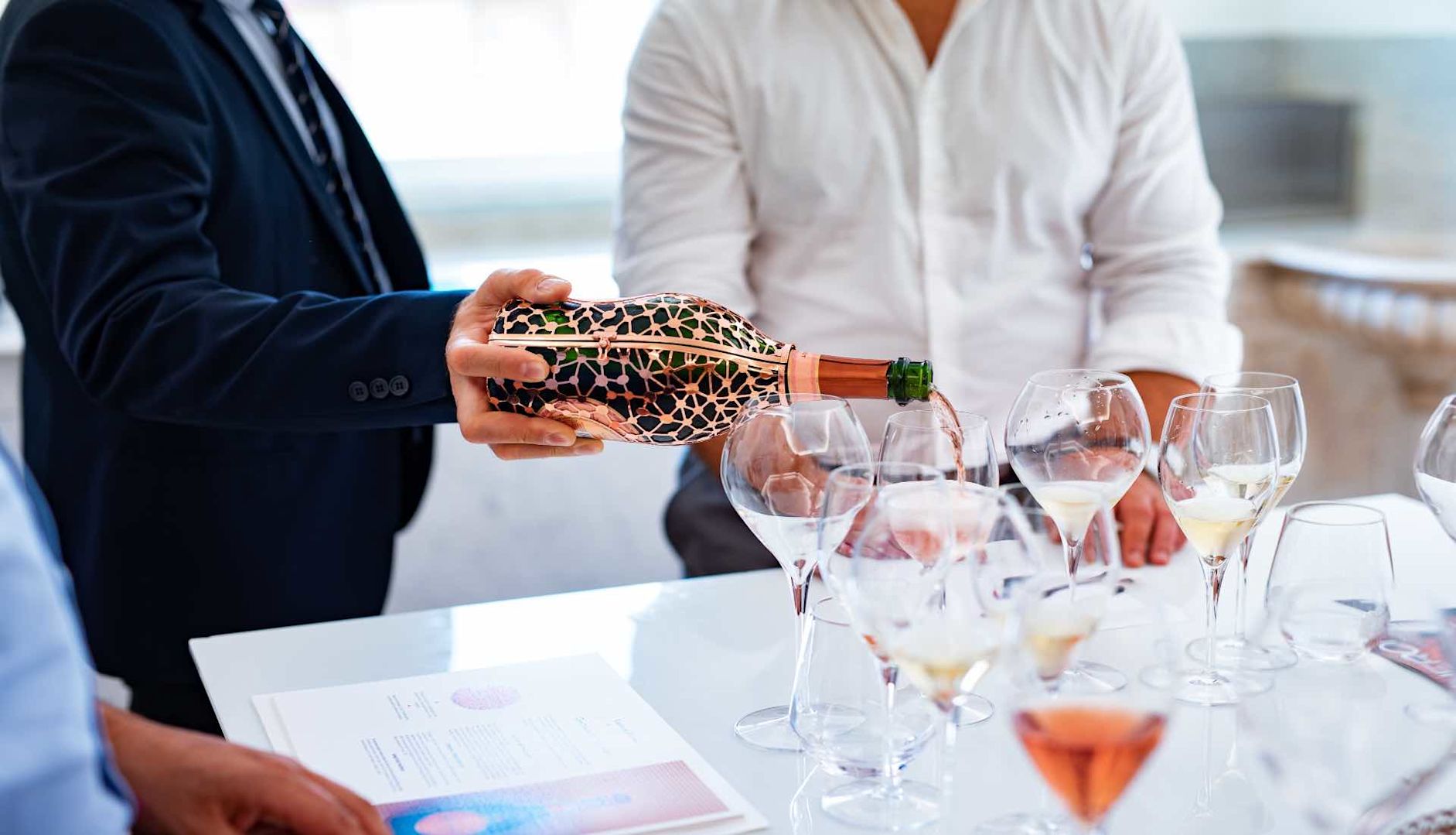 Wine being poured into glasses during Champagne visit to Laurent Perrier