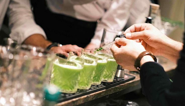 Shamrock sour cocktails being made at the bar