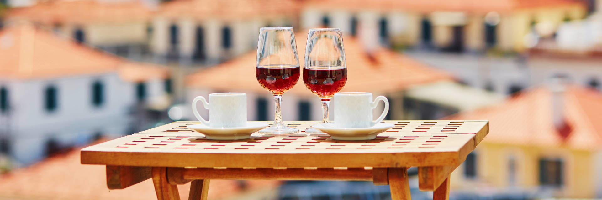 Madeira wine - two glasses of Madeira wine and coffee on a table in Madeira