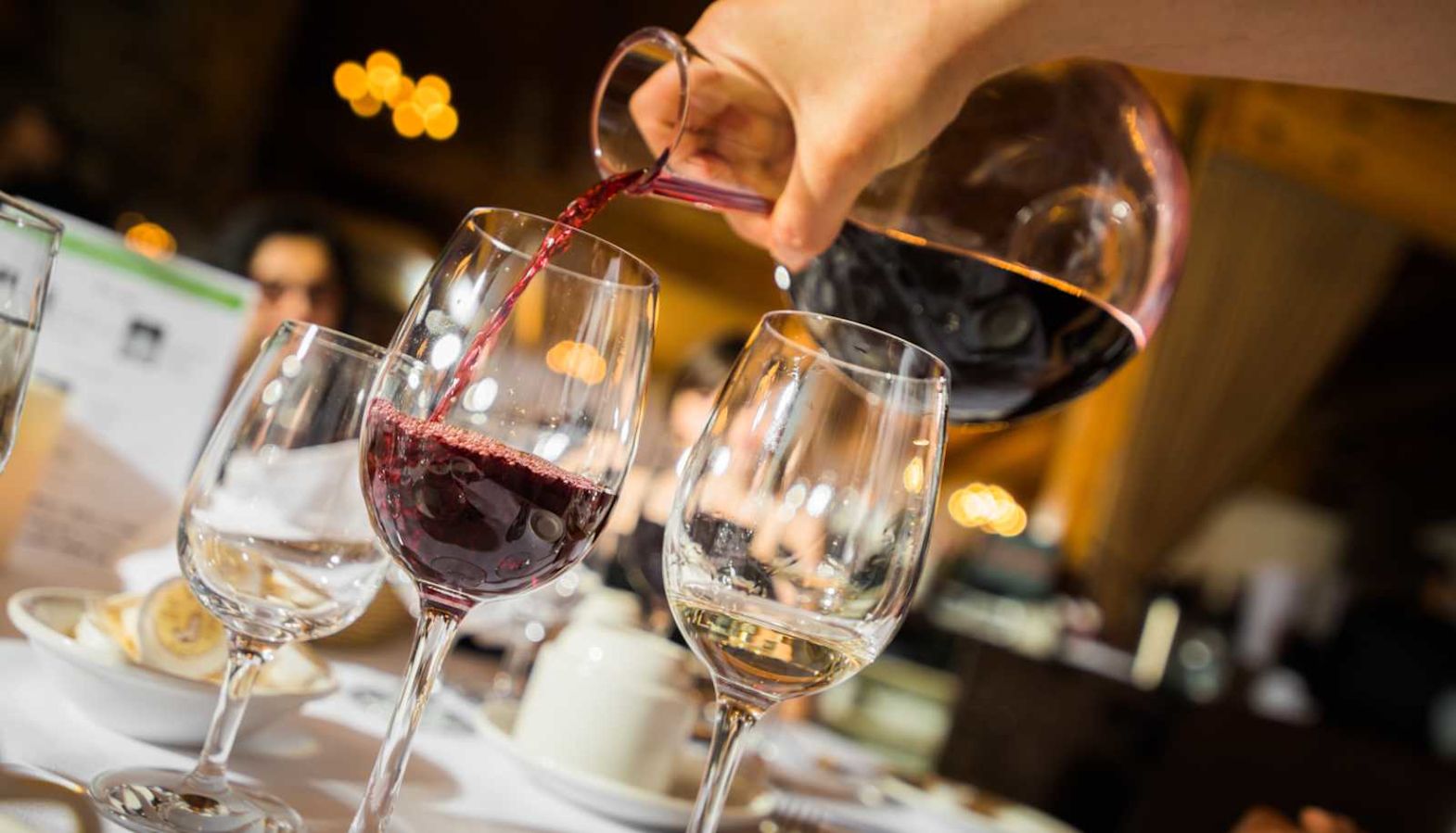 Wine aeration - someone pours wine from a decanter