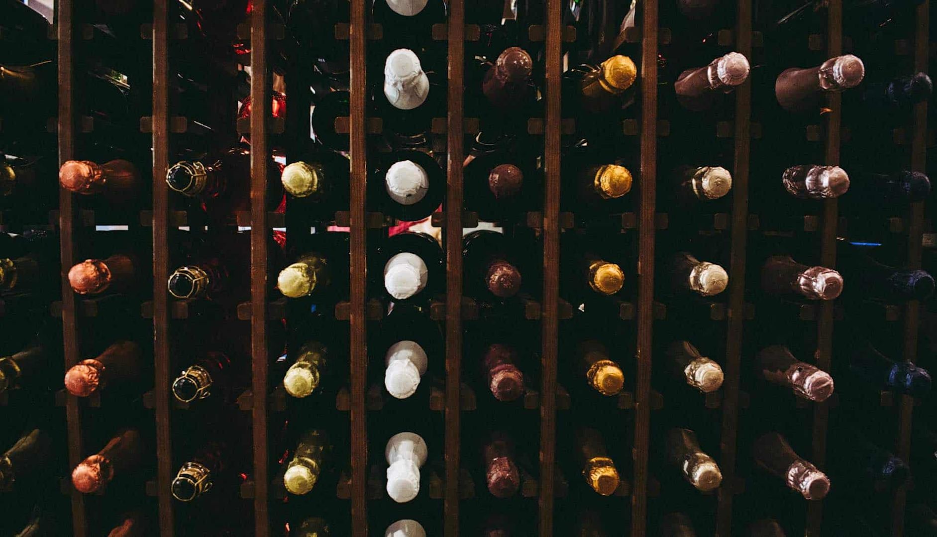 Several wine bottles stored on horizontally in wine racks