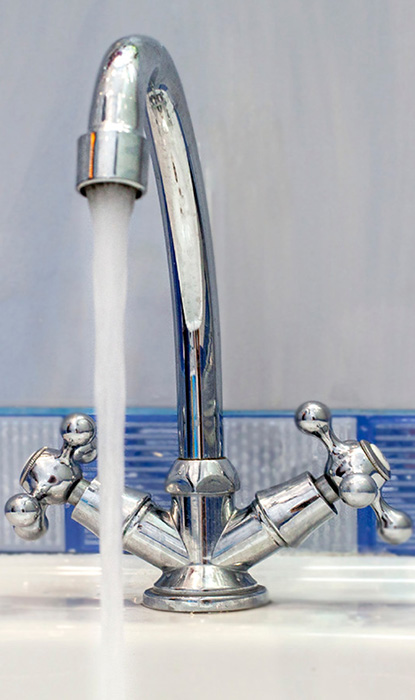 Water flows out of the bathroom counter faucet