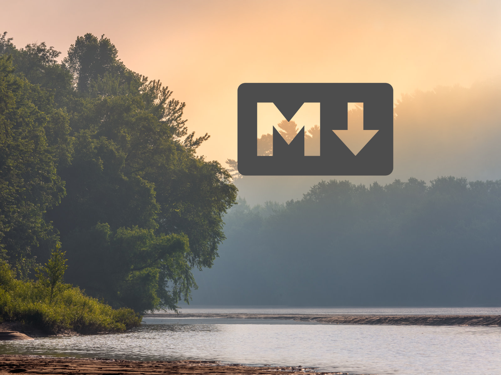 Markdown Logo in dark grey in front of a background of the Yukon River with slight fog in the early morning hours.