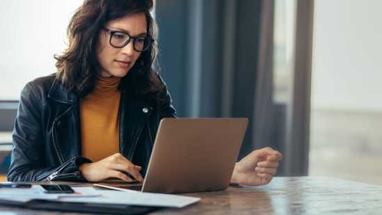 Woman at laptop taking employee engagement surveyy