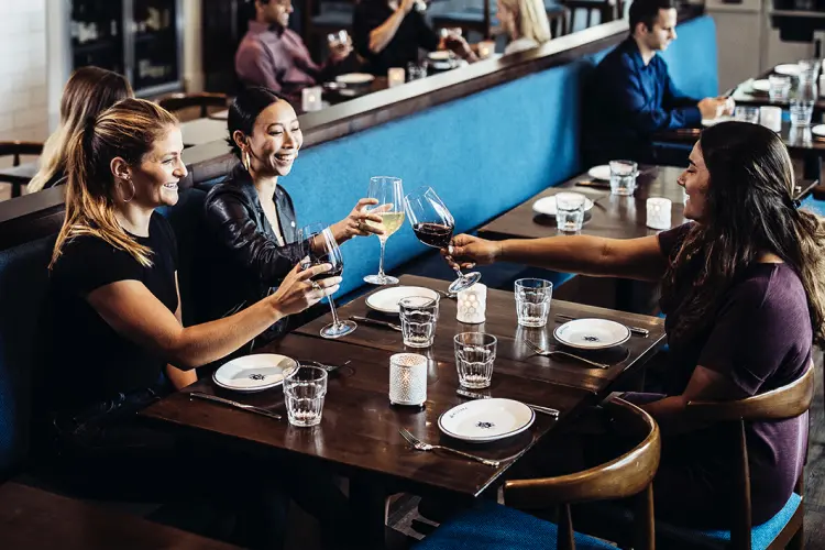 Restaurant party enjoying glasses of wine before their meal