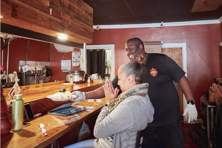 Guest happily getting their order at Roc-N-Ramen