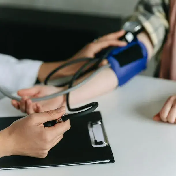 Taking-blood-pressure-at-FQHC-610x610