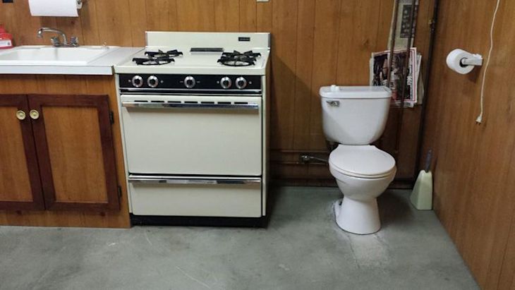 Toilet installed in the kitchen, next to the stove