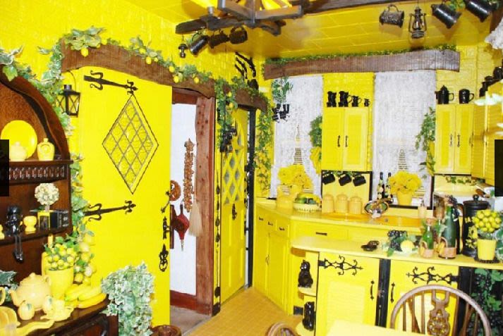 A kitchen painted throughout in bright, nuclear yellow