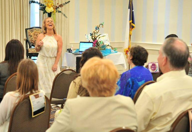 Janelle Hoyland Laughing While Speaking During An Event