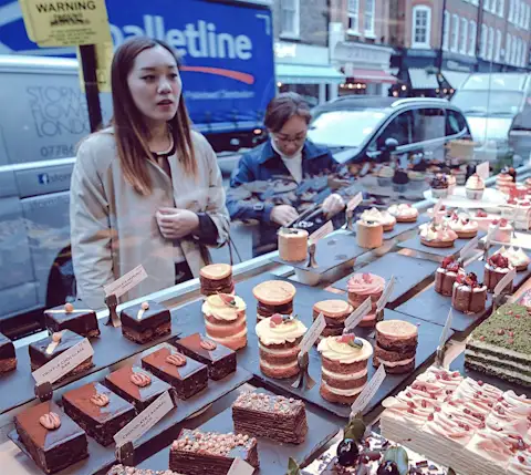 Mx Blog  - 18 Effective Restaurant Promotion Ideas to Grow Your Business - woman looking at pastries