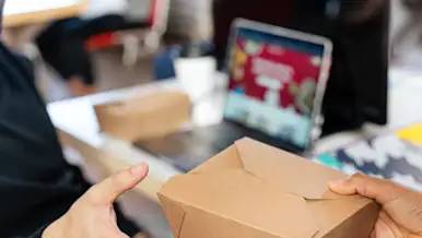 Someone receiving takeout for what could be a group meal