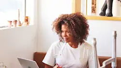 Woman sitting in front of laptop