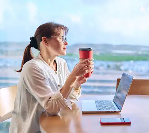 DDfB - Blog - What Is a Chronotype and How Is It Making Flexible Work More Productive? - woman with coffee in front of laptop
