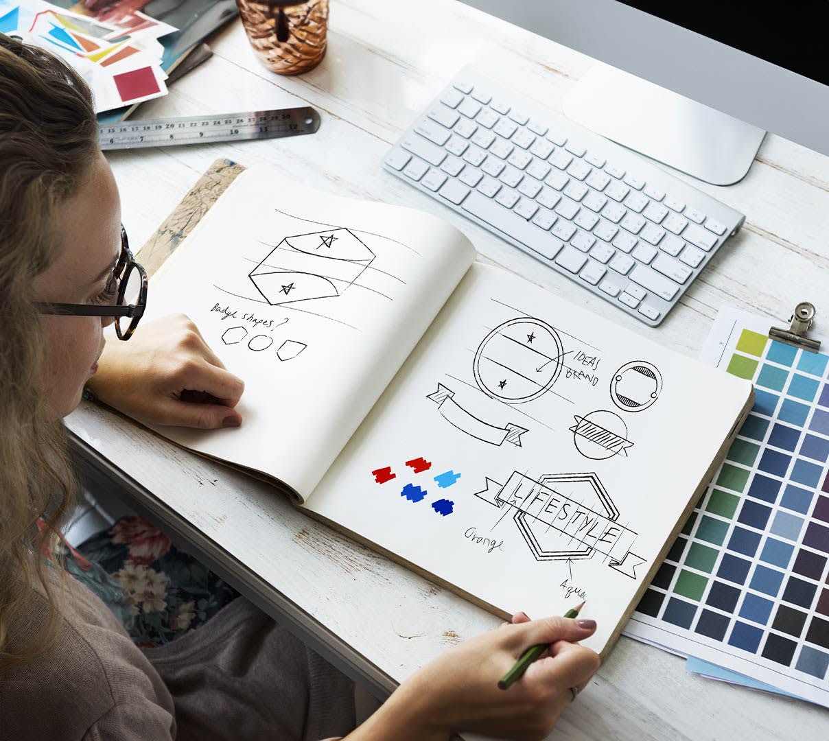 Mx Blog - How to Design a Restaurant Logo That Will Build Your Brand - Designer sketching logo ideas