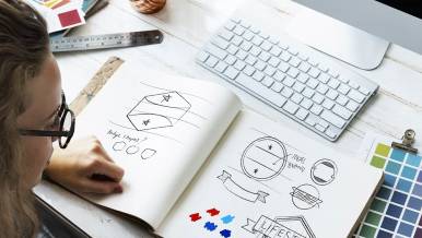 Mx Blog - How to Design a Restaurant Logo That Will Build Your Brand - Designer sketching logo ideas