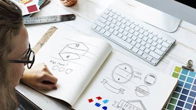 Mx Blog - How to Design a Restaurant Logo That Will Build Your Brand - Designer sketching logo ideas