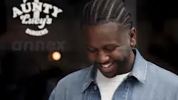 Owner of Aunty Lucy's Burgers outside of shop