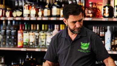 Alcohol merchant packages liquor at the counter