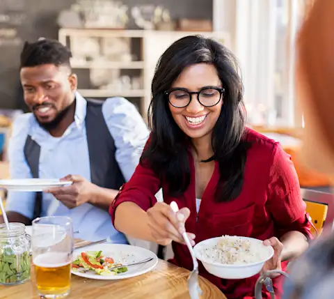 DDfB - Blog - How to Celebrate Cultural Diversity in the Workplace Through Food - woman eating with colleagues