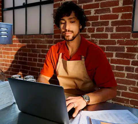 Male Restaurant owner working on his laptop