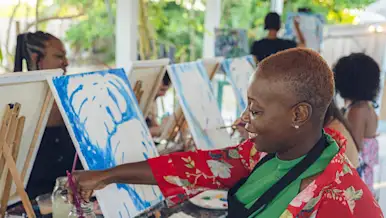 Woman painting with wine glass in hand