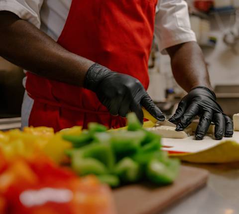Chef chopping bell peppers at Simply Irie