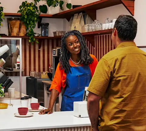 Mx Blog - Host Job Description - Hero Image - Barista counter service at coffee shop