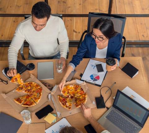 DDfB - Blog - How a Corporate Meal Allowance Can Help Your Business - employees reaching for pizza slices in boxes