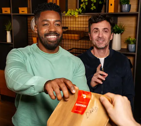 DDfB two men taking DoorDash delivery bags