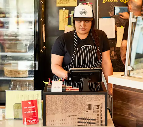 Women at point of sale tablet front of house