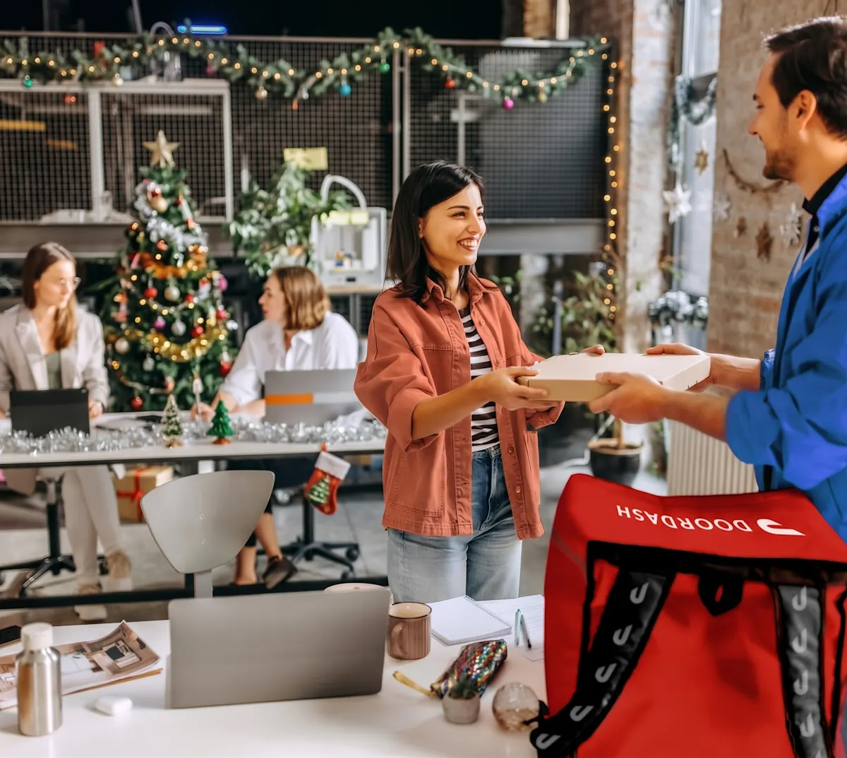 Dasher delivering a meal to a Christmas decorated office