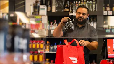 Mx Blog - The Most Popular Alcohol Trends 2024 - Worker at liquor store